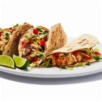 Baja Mahi Tacos · Grilled mahi served in warm flour tortillas with pico de gallo, fresh cabbage and a special ...