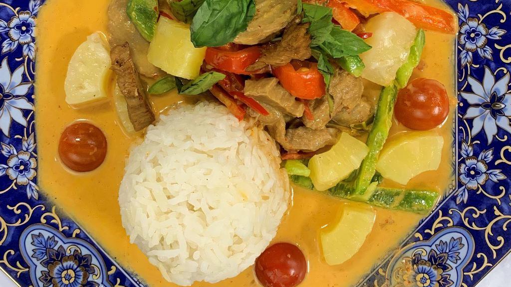 Vegan Duck Curry · Spicy red curry paste, pineapple, tomatoes, bell peppers, basil, and vegan duck. Served with choice of rice.
