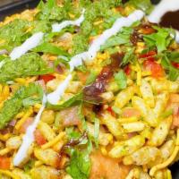 Bhel Poori · Spiced puffed rice tossed with tomatoes, onions, cilantro, sev, tamarind and cilantro-mint c...