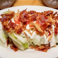 Wedge Salad · Lettuce, tomato, bacon, crispy shallot, homemade blue cheese dressing.