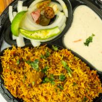 Chicken Biryani · Chicken sauteed in herbs mild spices with basmati rice and nuts.