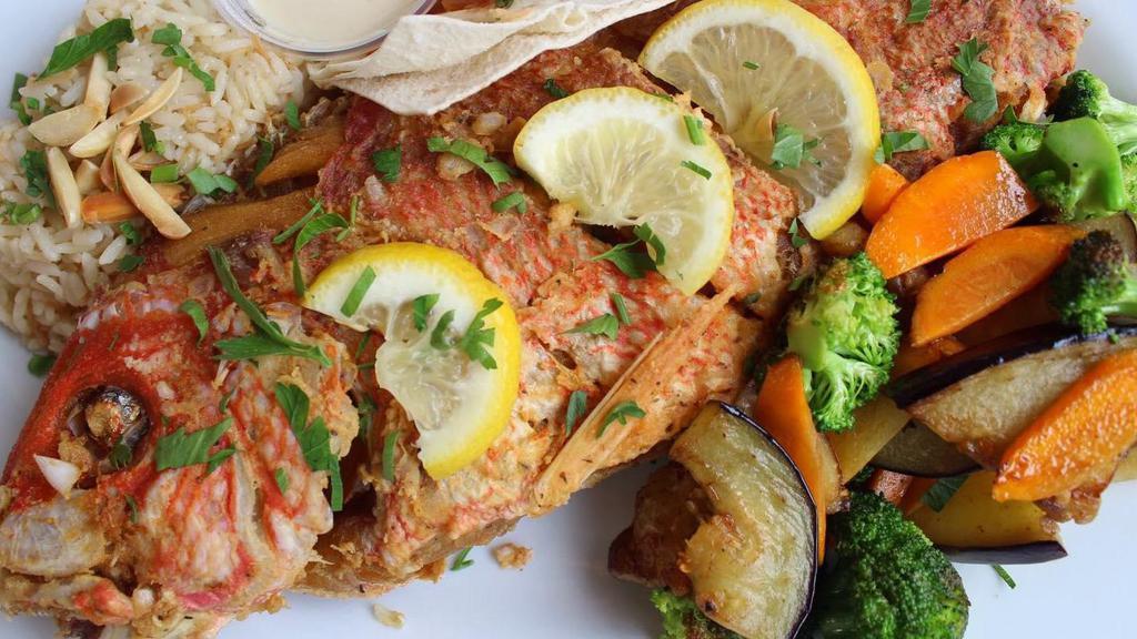 Fried Red Snapper · Deep fried red snapper with tahini sauce and syrian spices.