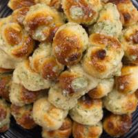 Garlic Knots (4) · Bread, topped with garlic & olive oil or butter, herb seasoning, baked to perfection. Melts ...