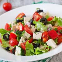 Greek Salad · Romaine lettuce, feta cheese, grape leaves, tomatoes, olives, onions, and balsamic vinegar.