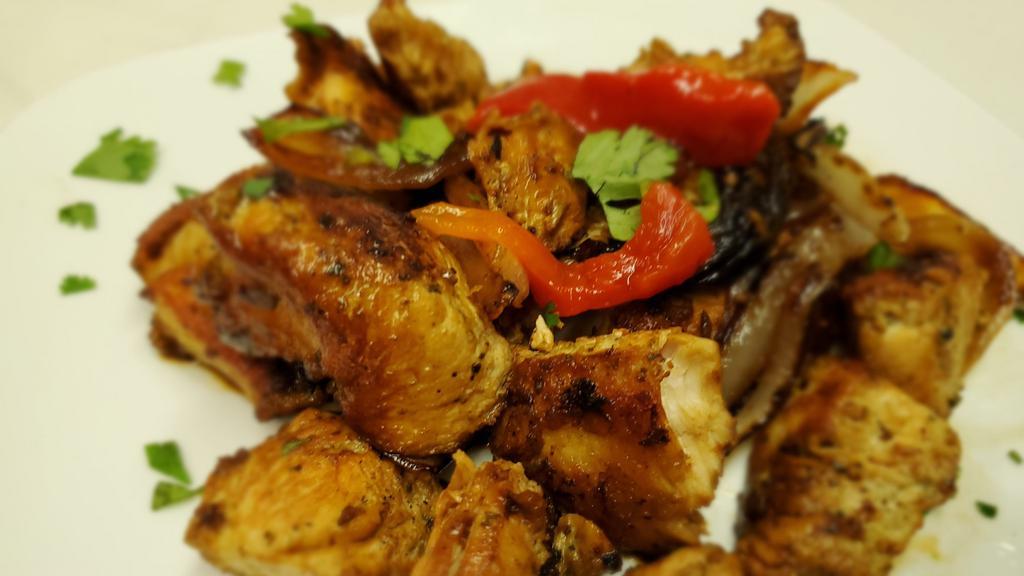 Pollo Boracho (Drunken Chicken) · Cut and Cubed Chicken Breast Marinated in Sofrito and Beer.  Pan Seared w/ Sauteed Onions