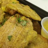 Tostones Con Mojito · Fried green plantains served with garlic and oil.