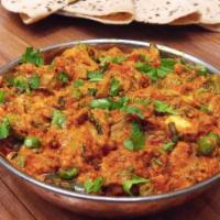 Vegetable Kolhapuri · Spicy. Mix vegetable cooked in Maharashtrian style in spicy red gravy. Served with basmati r...