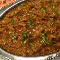 Baingan Bharta · Baked eggplant puree cooked with tomato, onion, and herbs. Served with basmati rice on side.
