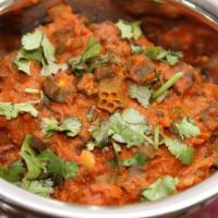 Bhindi Masala · Tangy preparation of diced okra tossed with onion, tomato, and spices. Served with basmati r...