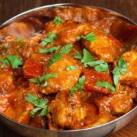 Chicken Curry (Roganjosh) · Chicken cooked in fresh onion, ginger, garlic, tomato, spices, and herbs. Served with basmat...