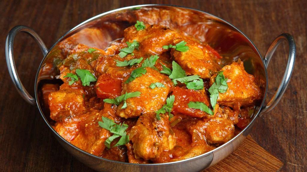 Chicken Curry (Roganjosh) · Chicken cooked in fresh onion, ginger, garlic, tomato, spices, and herbs. Served with basmati rice on side.