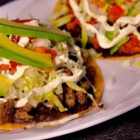 Tostada (2)
 · Crunchy Deep Fried Tortilla Topped With your Choice of Meat, Refried Bean Spread, Cotija Che...