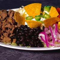 Taco Salad
 · With Meat On a Bed of Lettuce, Tomato, Red Onions, Avocado, Corn, Black Beans, Topped With T...