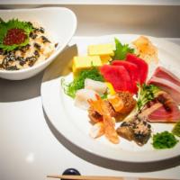 Chirashi · Assorted sashimi and side of sushi rice with ikura, nori, and sesame seeds.