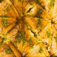 Baklava · Layer of phyllo dough with walnuts smothered in traditional syrup.