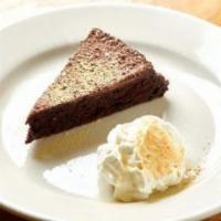 Warm Flourless Chocolate Cake · Served with organic whipped cream.