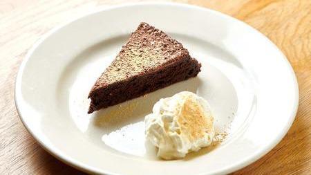 Warm Flourless Chocolate Cake · Served with organic whipped cream.
