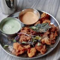 Kerala Chicken Fry · Spicy chickpea battered crispy chicken served with onions and lemon.