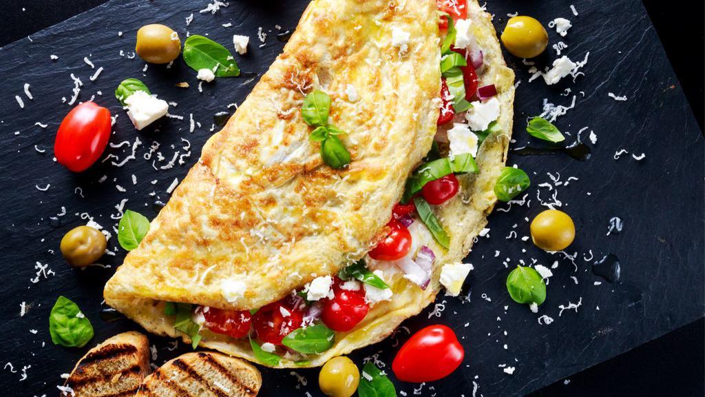 Greek Omelette · Delicious omelette with feta, onions, tomatoes, peppers, and american cheese.