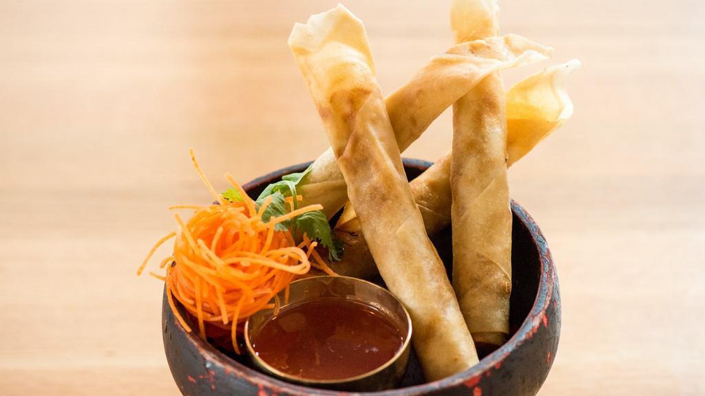 Crispy Spring Roll · Carrots, cabbage and taro folded in vermicelli. Served with sweet pomegranate & plum vinaigrette dipping sauce.