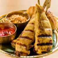 Chicken Satay · Grilled marinated chicken served with our creamy peanut sauce and cucumber vinaigrette dippi...