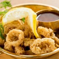 Crispy Calamari · Crispy fried calamari in our house blend batter served with sweet chili dipping sauce.