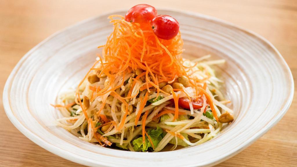 Papaya Salad · Spicy level 1, gluten-free. Shredded green papaya, tomatoes, string beans and peanuts tossed in an exotic Thai spicy lime dressing.
