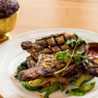 Lemongrass Pork Chop · Grilled premium cut of pork marinated with honey lemongrass sauce. Served with steamed cocon...