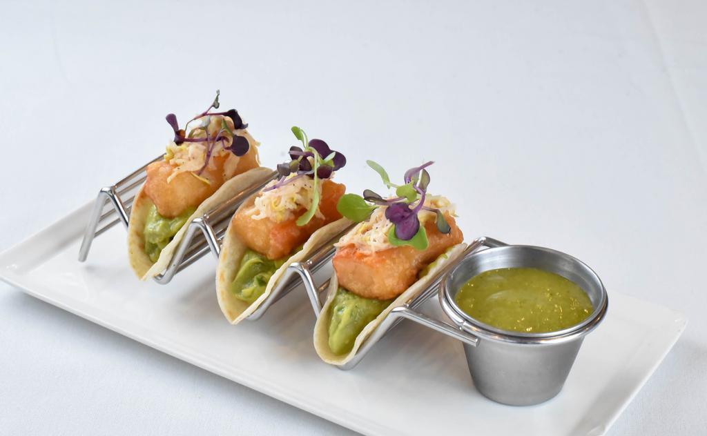 Kani Tacos · Beer Battered Kani Fritters, Pineapple Guacamole, Coleslaw, and Spicy Salsa Verde.