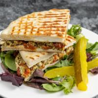 Italiano Panini · Grilled chicken, mozzarella cheese, roasted peppers and pesto sauce. Served with chips, pick...