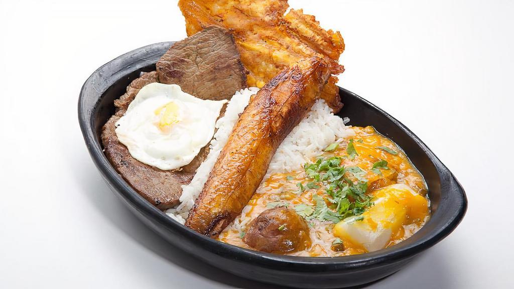 Grilled Steak With Creole Sauce · Grilled steak, fried egg, fried sweet plantain, fried green plantain, cassava, and potatoes in creole sauce served with rice.
