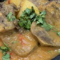 Stewed Beef Tongue · Beef tongue in creole sauce with cassava and potato served with rice and plantains.