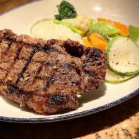 Chargrilled 12 Oz New York Strip Steak · Served with French fries, bacon wedge salad with choice of blue cheese dressing or lemon vin...