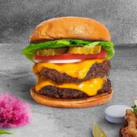 Double Trouble Vegan Burger · Two seasoned Impossible patties topped with melted vegan cheese, lettuce, tomato, onion, and...