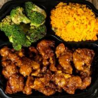 Orange Chicken · orange chicken over yellow rice and broccoli with brown sauce