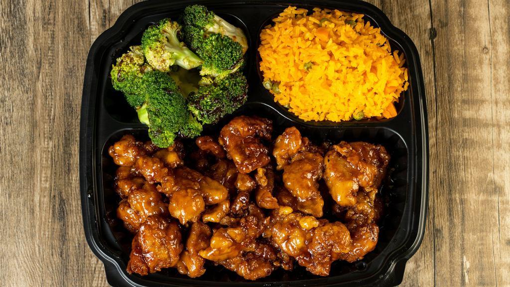 Orange Chicken · orange chicken over yellow rice and broccoli with brown sauce
