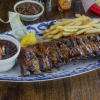 Baby Back Ribs · Tender, pulled-off-the-bone baby back ribs with a spicy jalapeño jelly. Served with French f...