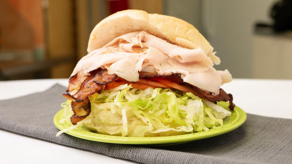 Classic Turkey Club · Roast turkey, bacon/ lettuce, tomato and mayo on a toasted hero.