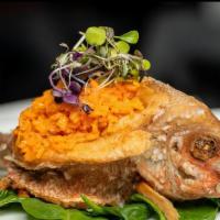 Pescado Entero Frito Relleno De Arroz De Vegetales/ Fried Whole Fish Stuffed With Vegetable Rice. · Served with the side of your choice.