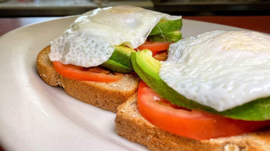 Avocado Toast Special · Avocado Toast with 2 slices of multigrain bread, sliced avocado, sliced tomato and two over easy eggs on top.