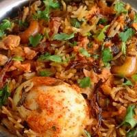 Egg Dum Biryani · Curried boiled eggs cooked in basmati rice with special herbs and spices.