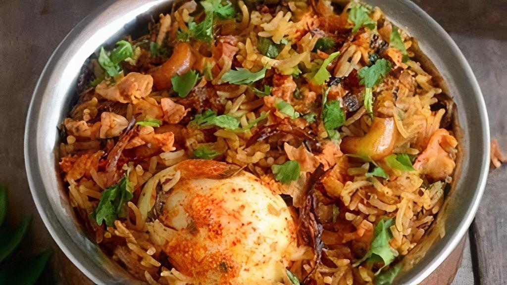 Egg Dum Biryani · Curried boiled eggs cooked in basmati rice with special herbs and spices.