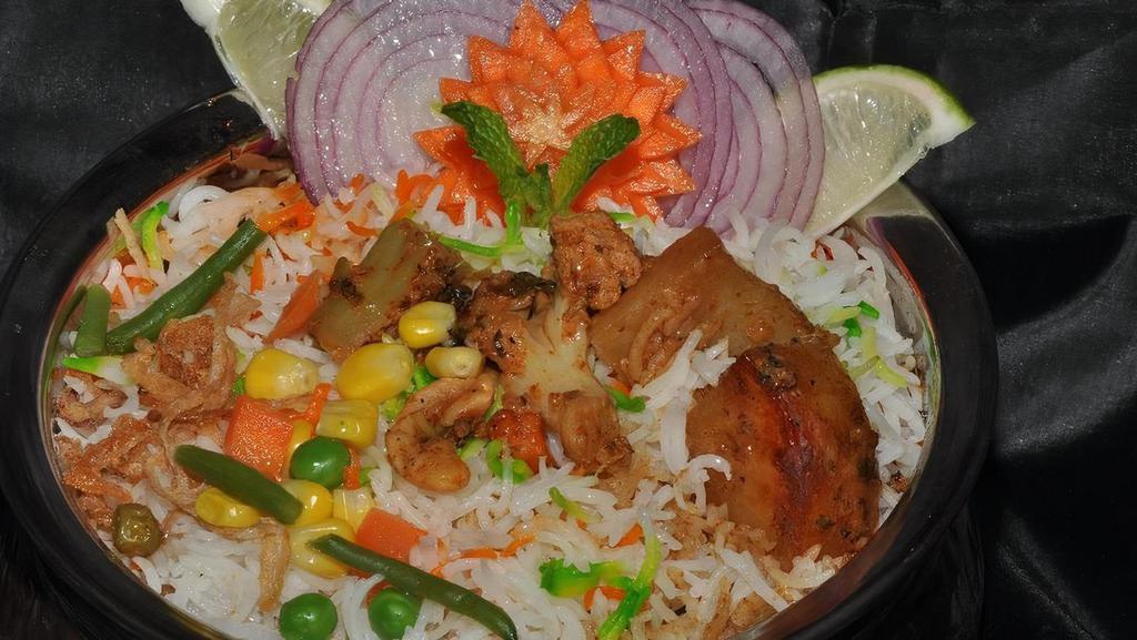 Vegetable Dum Biryani · Mixed vegetables cooked in basmati rice with special herbs and spices.