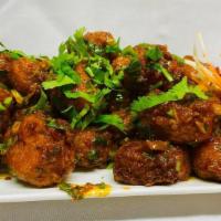 Manchurian · Battered gobi tossed with onion, bell pepper and manchurian sauce.