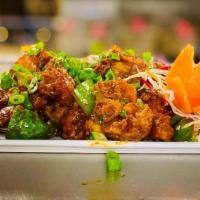 Chilli Appetizer · Battered gobi tossed with onion, bell pepper and chili sauce.