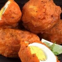 Egg Pakora · Boiled eggs mixed with spices, gram flour and deep fried.