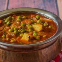 Aloo Mutter · Potatoes and peas cooked in tomatoes sauce with special spices.