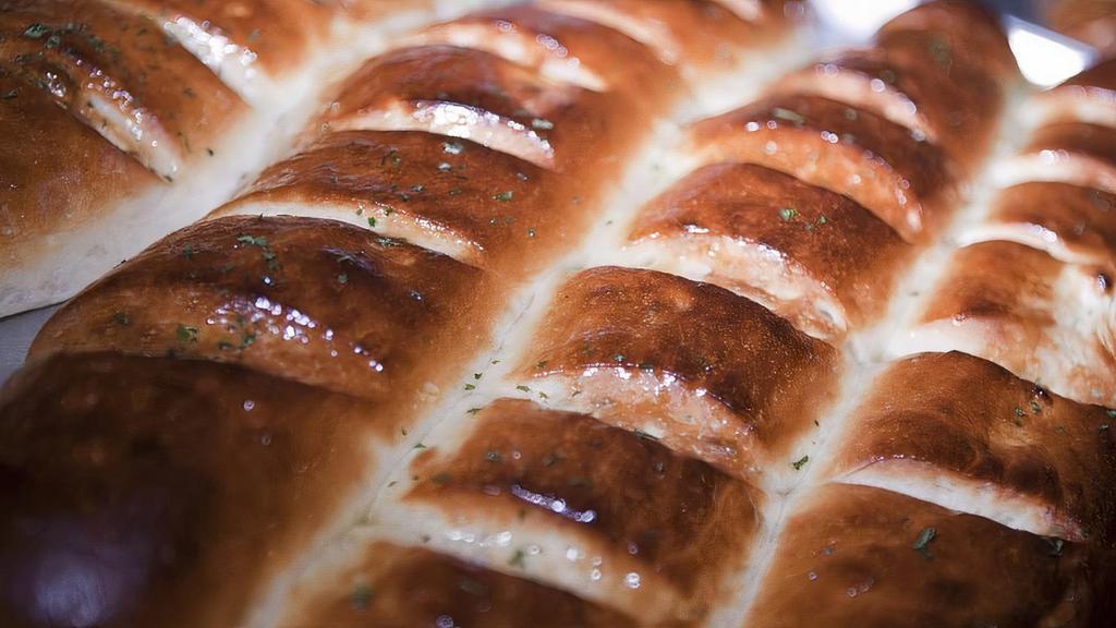 Garlic Bread · Whole loaf, topped with garlic and olive oil or butter, herb seasoning, baked to perfection. Melts in your mouth and arouses the taste buds.