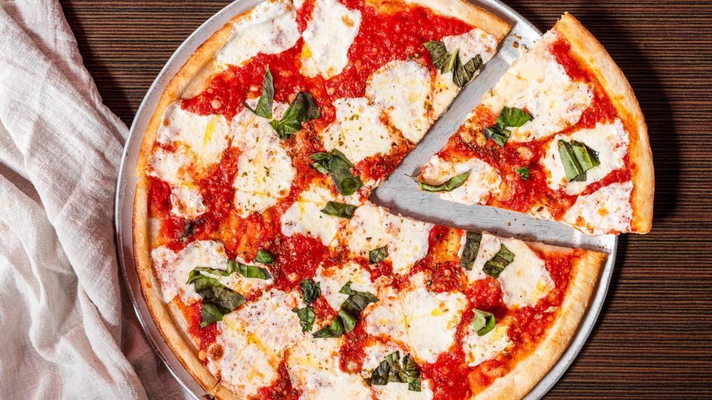 Margherita · Traditional Neapolitan style thin crust pizza topped with our crushed san marzano plum tomato sauce, fresh mozzarella, basil and a whisper of extra virgin olive oil.