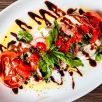 Mozzarella Di Casa · Gluten free. Fresh mozzarella served with flame roasted peppers, sliced market tomatoes and ...